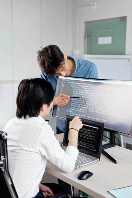 Diverse group of women working together in a modern office setting, fostering teamwork and creativity.